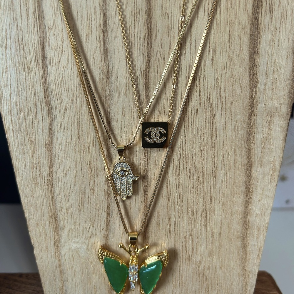 Layering necklaces. 3 styles available. Jade butterfly. Hamsa Hand, and CC.